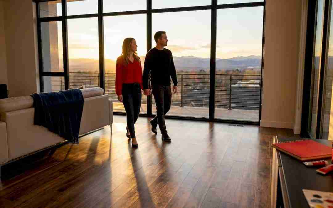 Couple walking on sunlit Denver hardwood floor