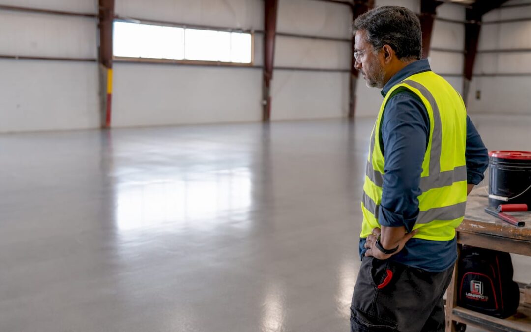 Facility manager inspecting coated commercial floor