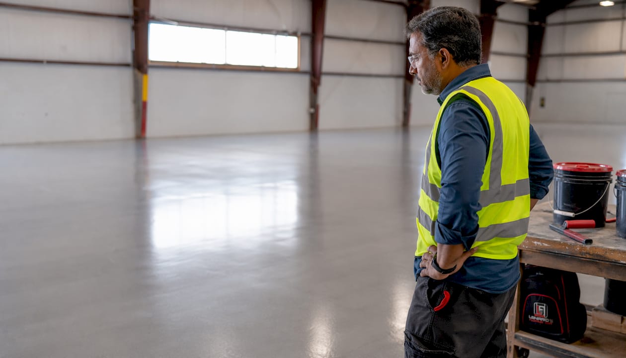 Facility manager inspecting coated commercial floor