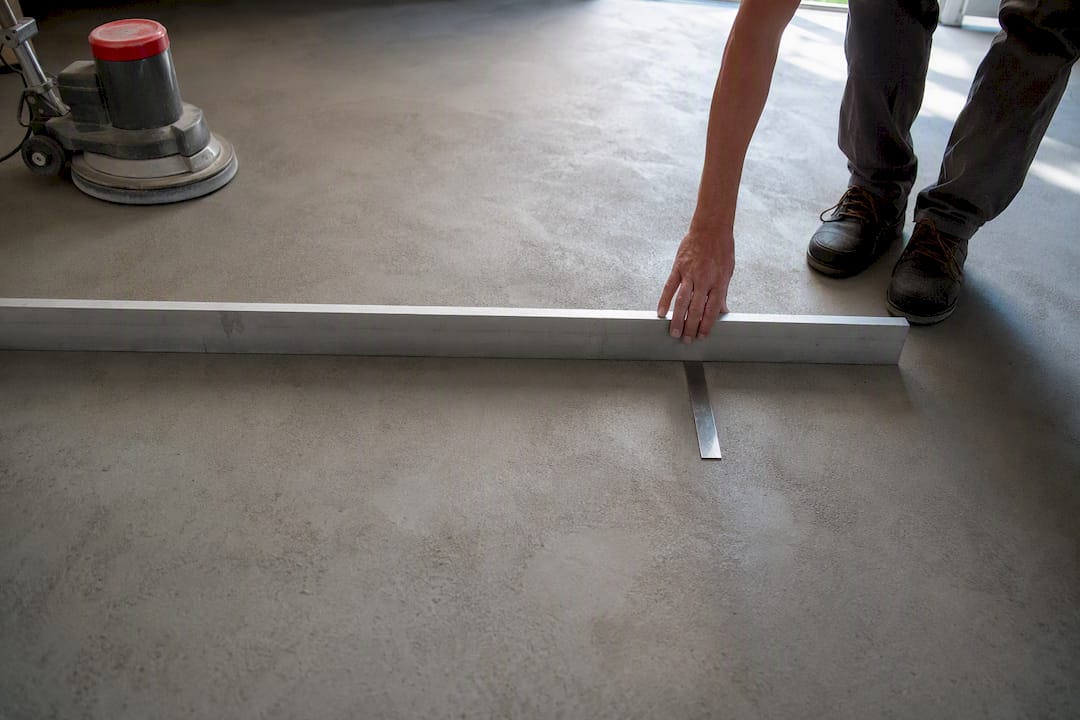 Straightedge and feeler gauge testing slab flatness